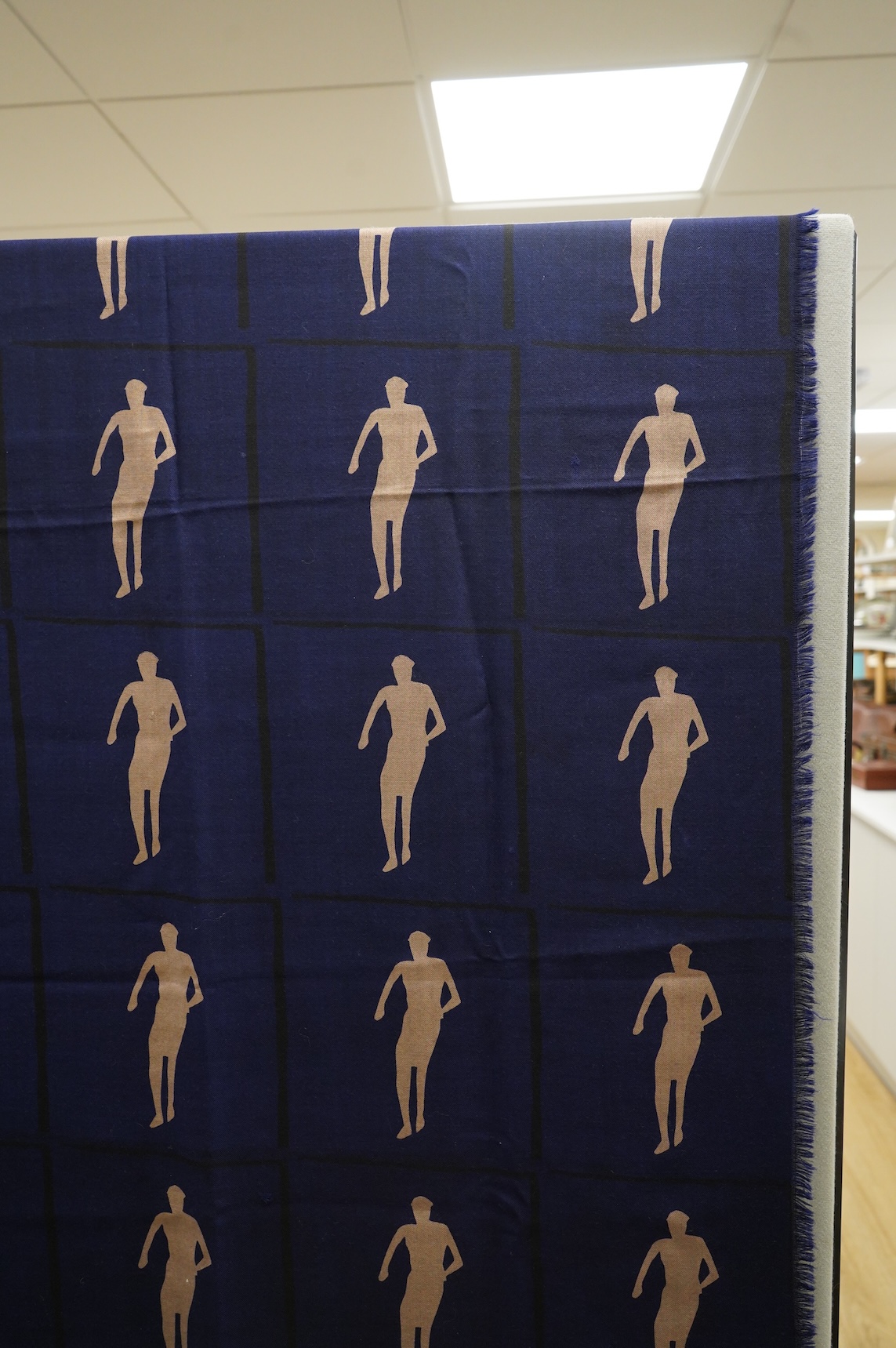 A 1983 blue wool hand printed beige cut out figures fringed - designed by Fraser Taylor of ‘The Cloth’ (RCA 1983)., 97cm x 294cm long. Condition - good